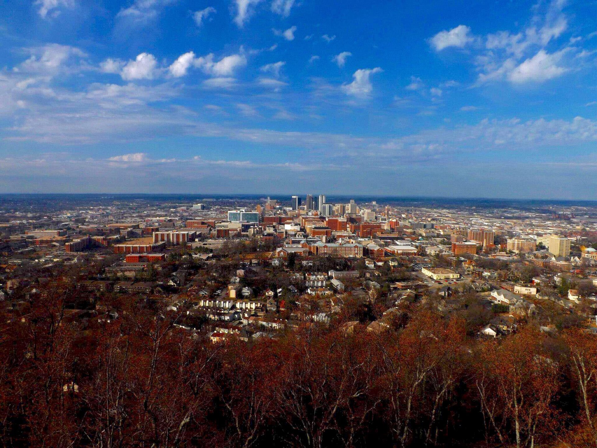 Downtown Birmingham skyline seen from Vulcan Park under a blue sky
